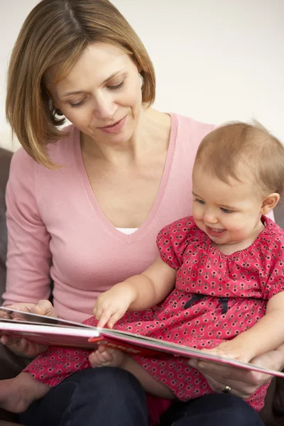Mother and Baby Daughter Reading Book — стоковое фото