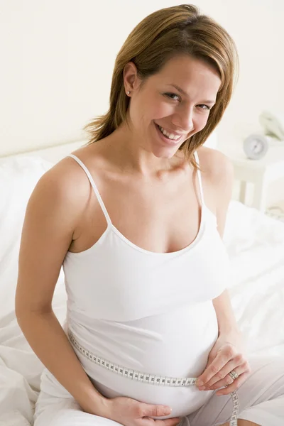 Pregnant Woman Bedroom Measuring Belly Smiling Royalty Free Stock Images