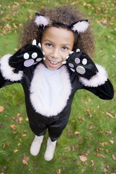 Young girl outdoors in cat costume on Halloween Stock Image