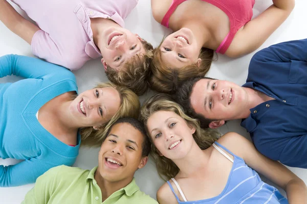 Teenagers Lying Down Head To Head Stock Image