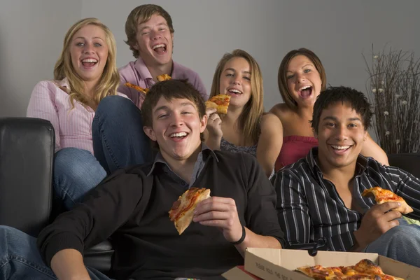 青少年很开心，吃披萨 免版税图库照片