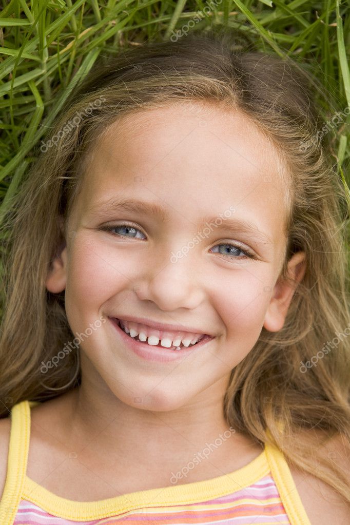 Young Girl Lying Down On The Grass — Stock Photo © monkeybusiness #4780374