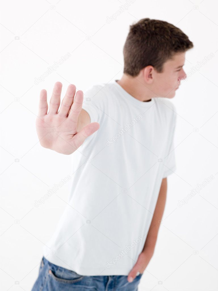 Teenage boy standing with hand up smiling — Stock Photo 