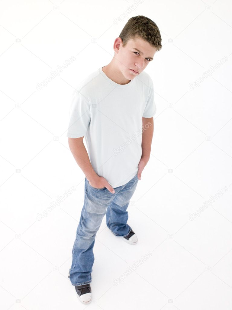 Teenage boy standing with hands in pockets Stock Photo by ...