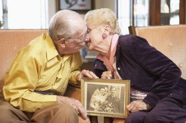 Senior couple holding wedding photo clipart