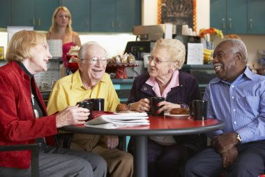 Senior adults having morning tea together clipart