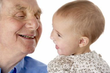 Portrait of grandfather and granddaughter, smiling at each other clipart