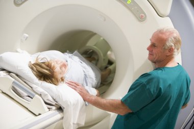 Doctor With Patient As They Prepare For A Computerized Axial Tomography (CAT) Scan clipart