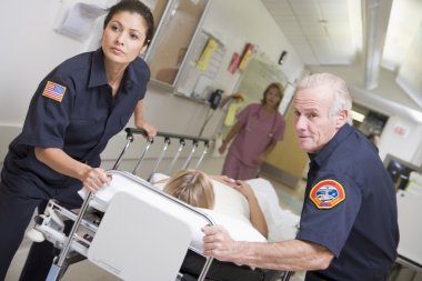 Paramedics Rushing Emergency Patient Into Hospital clipart