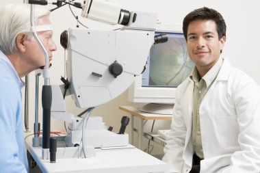 Doctor And Patient Ready For An Eye Exam clipart