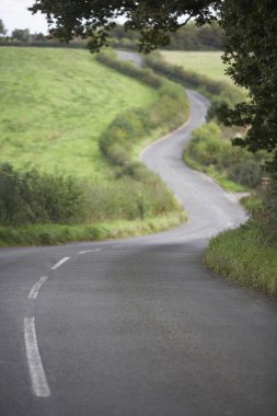 Road Winding Its Way Through The Countryside clipart