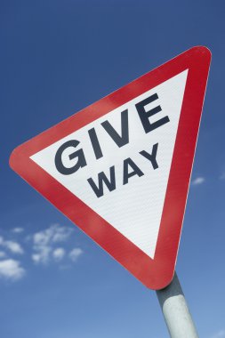 Give Way Sign Against A Blue Sky clipart