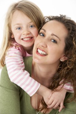 Portrait Of Cuddling Mother And Child clipart