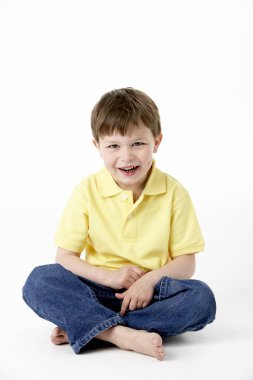 Young Boy Sitting In Studio clipart