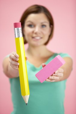 Woman Holding Big Pencil And Eraser clipart