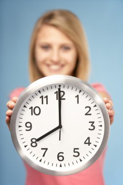 Teenage Girl Holding Clock clipart