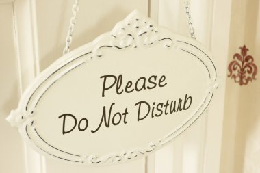 Do Not Disturb Sign Hanging On Door clipart