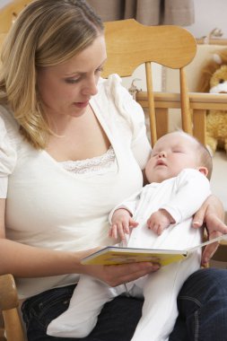 Mother Reading Story To Baby In Nursery clipart