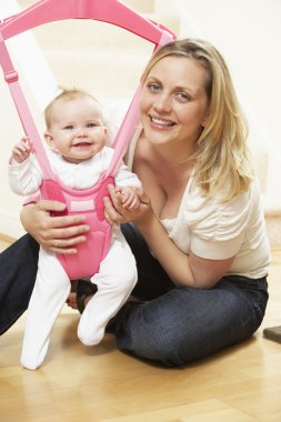 Baby In Bouncer With Mother clipart