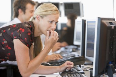 Anxious Woman Looking At Computer Monitor clipart