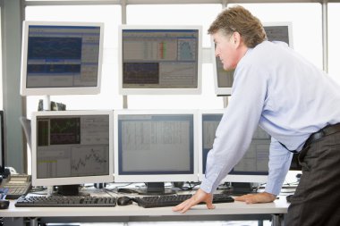 Stock Trader Examining Computer Monitors clipart