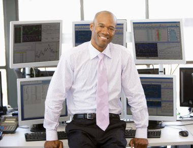 Portrait Of Stock Trader In Front Of Computer Monitors clipart