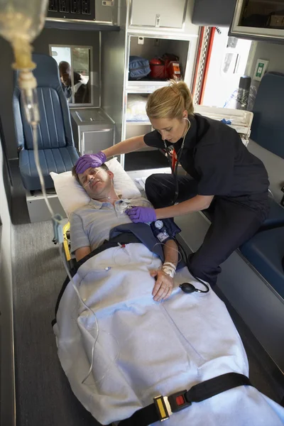 Paramedic with patient in ambulance — Stock Photo, Image
