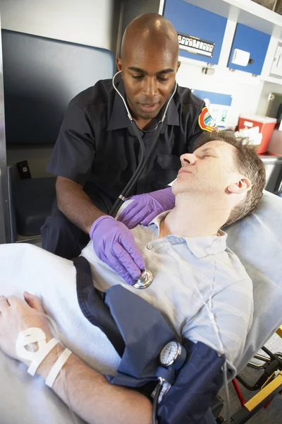 Paramedic attending to patient in ambulance — Stock Photo, Image
