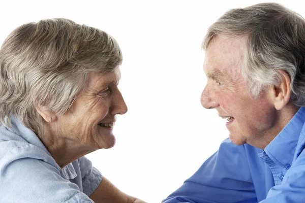 Portrait of senior couple smiling at each other — Stock Photo, Image