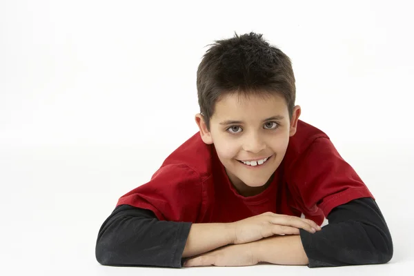 Young Boy Lying On Stomach In Studio — Stock Photo, Image