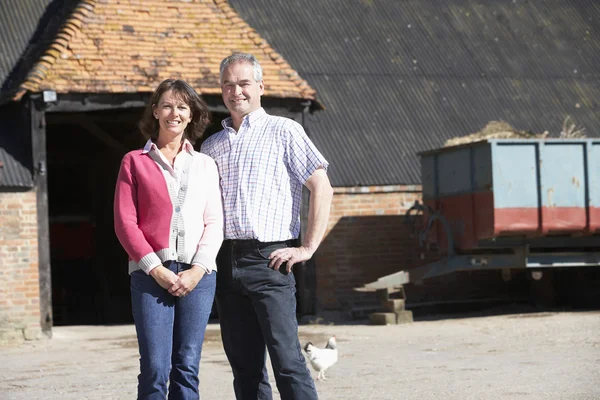 Farmer And Wife Standing In Front Of Farm Buildings — Stock Photo, Image