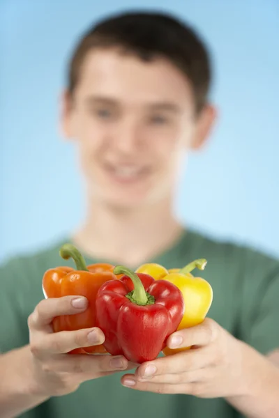 Teenage Boy Holding Fresh Peppers — Stock Photo, Image
