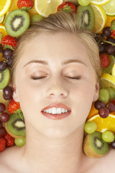 Portret młodej kobiety pośród owoców — Zdjęcie stockowe