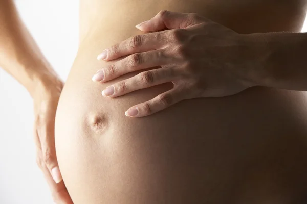 Деталь беременной женщины, держащей живот — стоковое фото