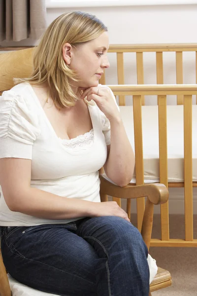 Sad Mother Sitting In Empty Nursery — Stock Photo, Image