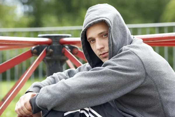 Young Man Sitting In Playground — Stock Photo, Image