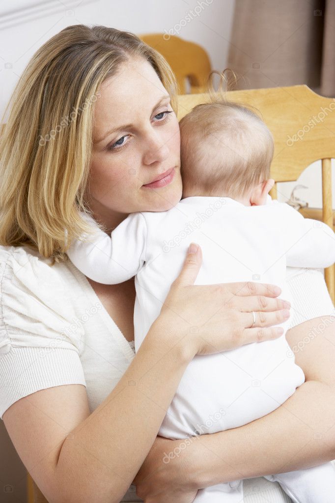 Worried Mother Holding Baby In Nursery — Stock Photo © Monkeybusiness