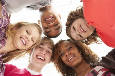 Five Teenage Friends Looking Down Into Camera clipart