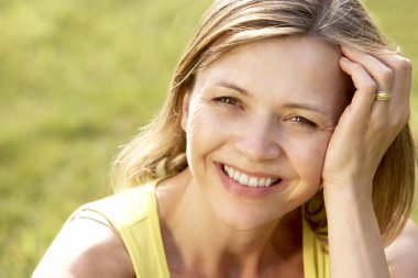 Portrait of young woman relaxing in countryside clipart