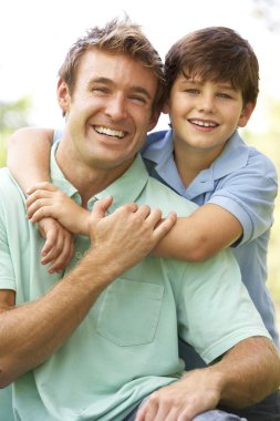 Portrait Of Father And Son In Park clipart