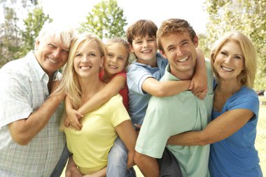 Mother And Father Giving Children Piggy Back With Grandparents clipart