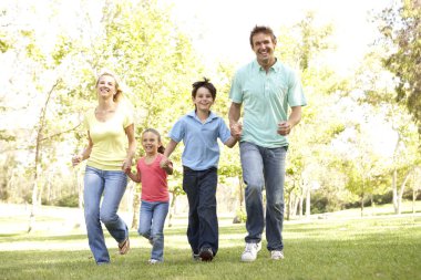 Family Running In Park clipart