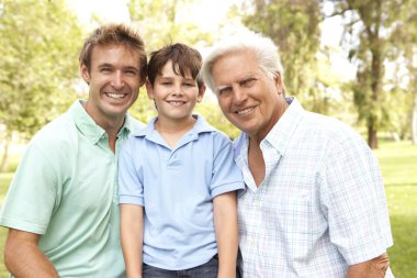 Grandfather With Father And Son In Park clipart