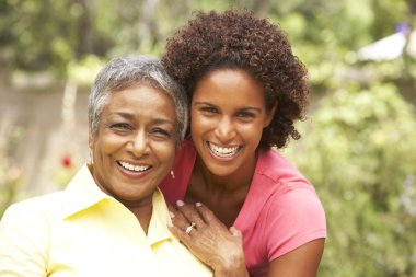 Senior Woman Hugging Adult Daughter clipart