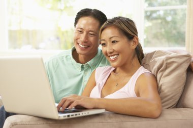 Young Couple Using Laptop At Home clipart