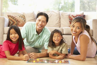 Family Playing Board Game At Home clipart