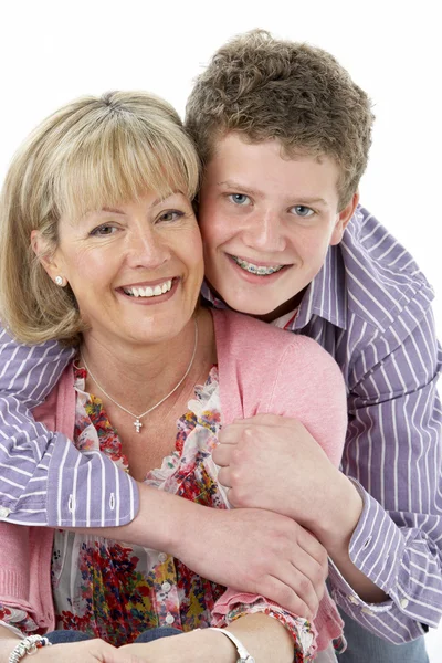 Studio Portrait of Smiling Teenage Boy with Mum — Stock Photo, Image