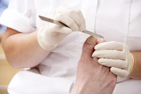 Chirpodist treating client in clinic — Stock Photo, Image