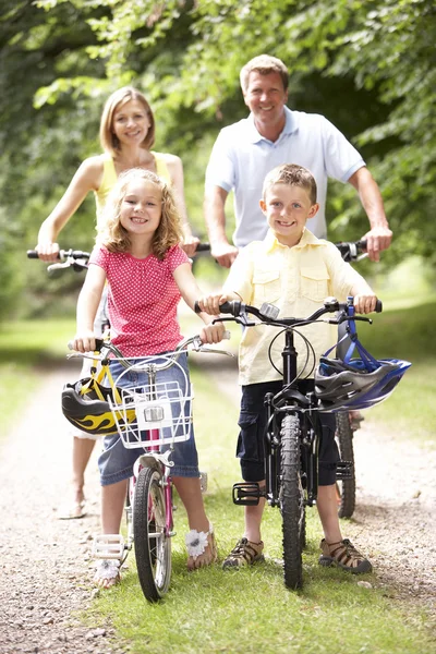 Bicicletas de equitação familiar no campo — Fotografia de Stock