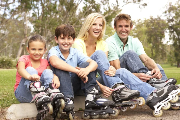 Family Putting Line Skates Park — Stock Photo, Image